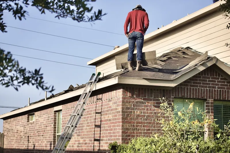 Professional roofer working on a residential roof in Brockton
